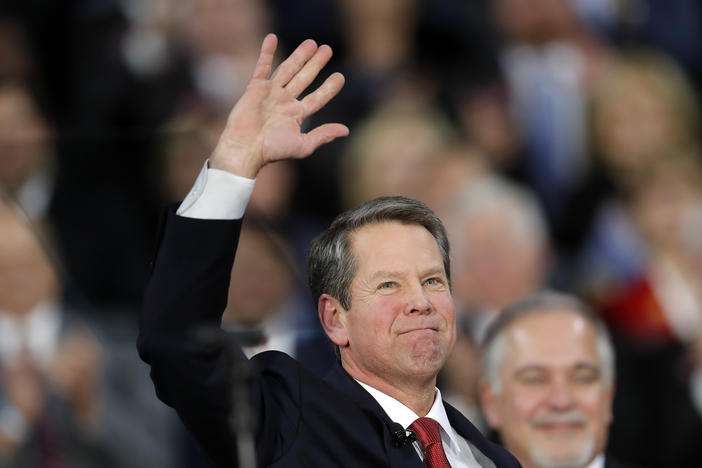 Brian Kemp waves after being sworn in as Georgia's governor during a ceremony at Georgia Tech's McCamish Pavilion in Atlanta.