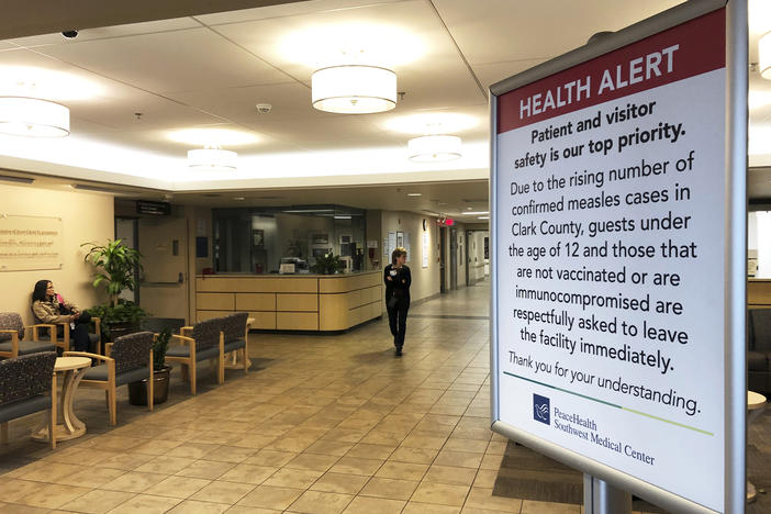 In this Jan. 25, 2019 file photo, a sign prohibiting all children under 12 and unvaccinated adults stands at the entrance to PeaceHealth Southwest Medical Center in Vancouver, Wash. Measles has been confirmed in Cobb County, Georgia, Nov. 9, 2019. 