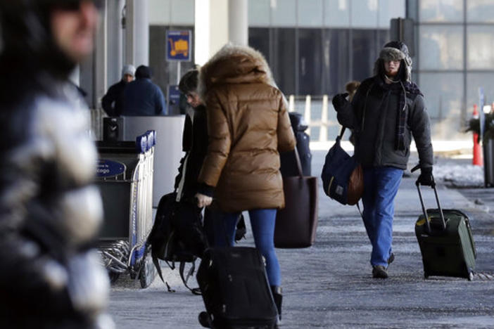 Passengers walk through Terminal 3 at O'Hare International Airport in Chicago, Thursday, Jan. 31, 2019. 