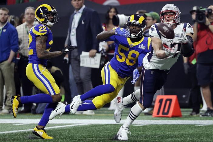 New England Patriots' Rob Gronkowski (87) catches a pass in front of Los Angeles Rams' Marcus Peters (22) and Cory Littleton (58) during the second half of the NFL Super Bowl 53 football game Sunday, Feb. 3, 2019, in Atlanta.