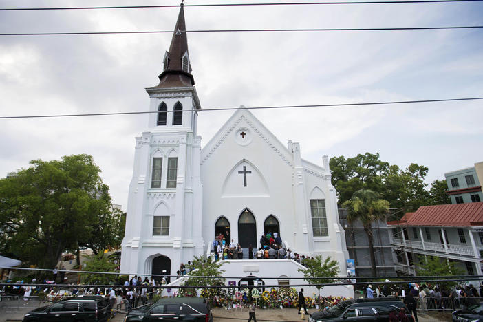 In this June 25, 2015, file photo, people line up to attend the wake of Sen. Clementa Pinckney, one of the nine killed in a shooting, at Emanuel AME Church in Charleston, S.C. 