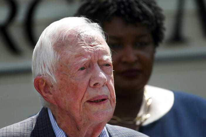 In this Sept. 18, 2018 file photo, former President Jimmy Carter speaks as Democratic gubernatorial candidate Stacey Abrams listens during a news conference to announce her rural health care plan, in Plains, Ga. Carter is now the longest-living president 