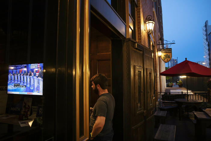 Sam Copeland watches as Democratic presidential candidate Sen. Bernie Sanders, I-Vt., speaks during a broadcast of a Democratic presidential debate in June 2019.