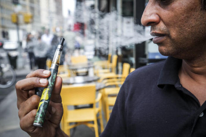 Inam Rehman, manager of Jubilee Vape & Smoke Inc., vapes while discussing New York Gov. Andrew Cuomo's push to enact a statewide ban on the sale of flavored e-cigarettes amid growing health concerns, Monday Sept. 16, 2019, in New York.