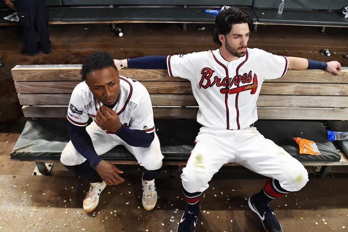 Atlanta Braves' Dansby Swanson, right, and Ozzie Albies sit in the dugout after the Braves lost 13-1 to the St. Louis Cardinals in Game 5 of their National League Division Series on Wednesday in Atlanta. 