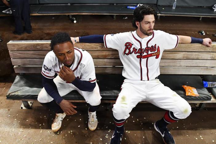 Atlanta Braves' Dansby Swanson, right, and Ozzie Albies sit in the dugout after the Braves lost 13-1 to the St. Louis Cardinals in Game 5 of their National League Division Series on Wednesday in Atlanta.