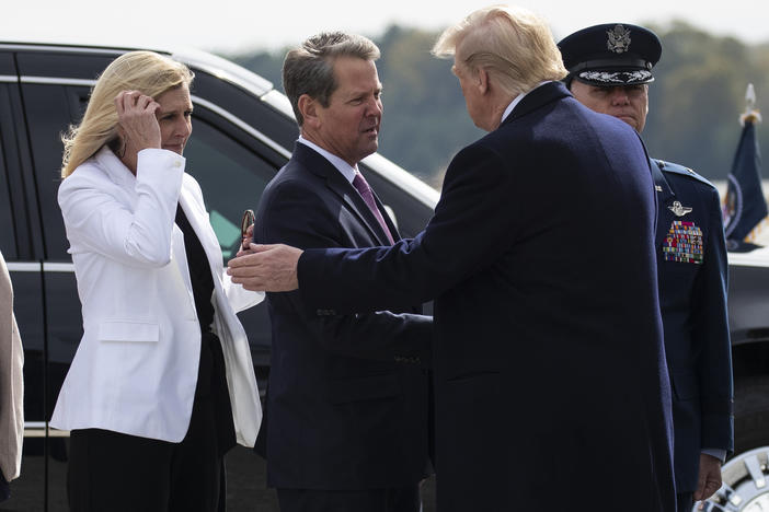 President Donald Trump is greeted by Gov. Brian Kemp, R-Ga., and his wife Marty Kemp after arriving at Dobbins Air Reserve Base to attend a fundraiser, and speak at the launch of "Black Voices for Trump," Friday, Nov. 8, 2019, in Marietta, Ga.