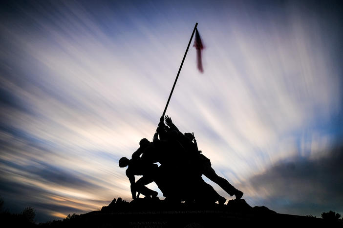 The sun sets behind the U.S. Marine Corps War Memorial in Arlington, Va., Sunday, Nov. 10, 2019, in this slow-shutter speed exposure. Veterans Day will be celebrated in the United States on Monday. 