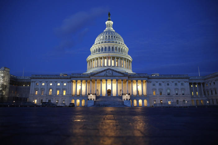 Light shines on the U.S. Capitol dome in Washington, early Wednesday, Dec. 4, 2019, prior to scheduled testimony from Constitutional law experts at a hearing before the House Judiciary Committee.