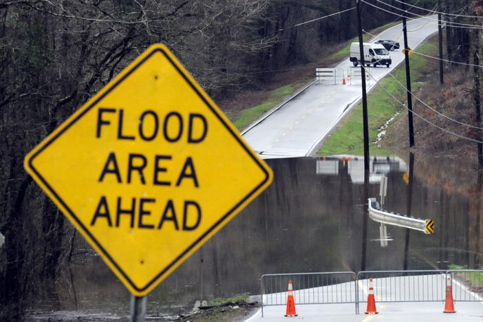 Vehicles turn around on a road blocked by floodwaters in Helena, Ala., on Tuesday, Feb. 11, 2020. 