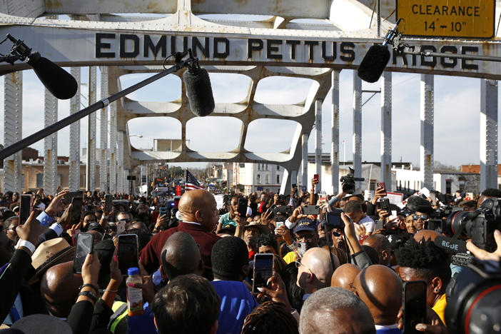 Rep. John Lewis, D-Ga., center in red, addresses a crowd on the Edmund Pettus Bridge in Selma, Ala., Sunday, March 1, 2020, during a commemoration of the 55th anniversary of "Bloody Sunday," when white police attacked black marchers in Selma.