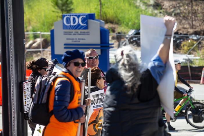 Protestors demonstrate in front of the Centers for Disease Control and Prevention headquarters on Friday, March 6, 2020 in Atlanta.