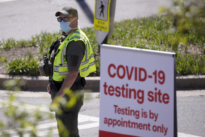 A police officer directs cars into a coronavirus testing facility at Georgia Tech Monday, April 6, 2020, in Atlanta.