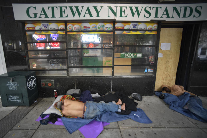 Homeless men sleep on Marietta Street Friday, June 5, 2020, in Atlanta.