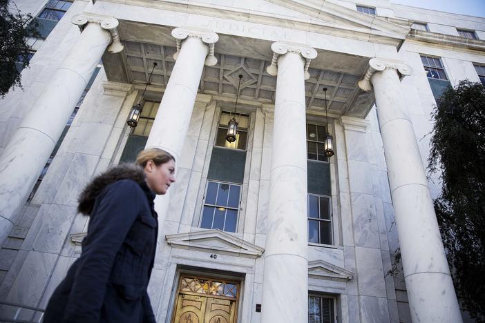 A pedestrian passes by the Georgia Supreme Court.