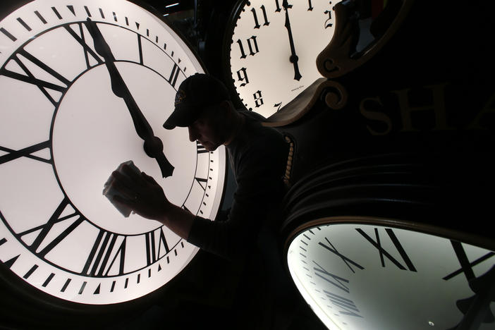 Dave LeMote wipes down a post clock at Electric Time Company, Inc. in Medfield, Mass., Friday, March 7, 2014.