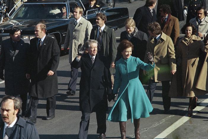This Jan. 20, 1977 photo shows President Jimmy Carter and First Lady Rosalynn Carter waving as they walk down Pennsylvania Avenue in Washington after Carter was sworn in as the nation's 39th president.
