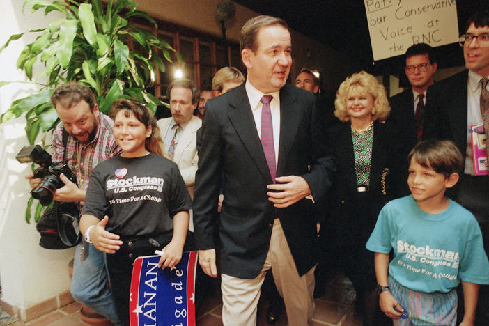 Conservative Republican Pat Buchanan, center, arrives in Houston for the 1992 Republican National Convention. There, he will deliver a defining speech in the history of the modern conservative movement.