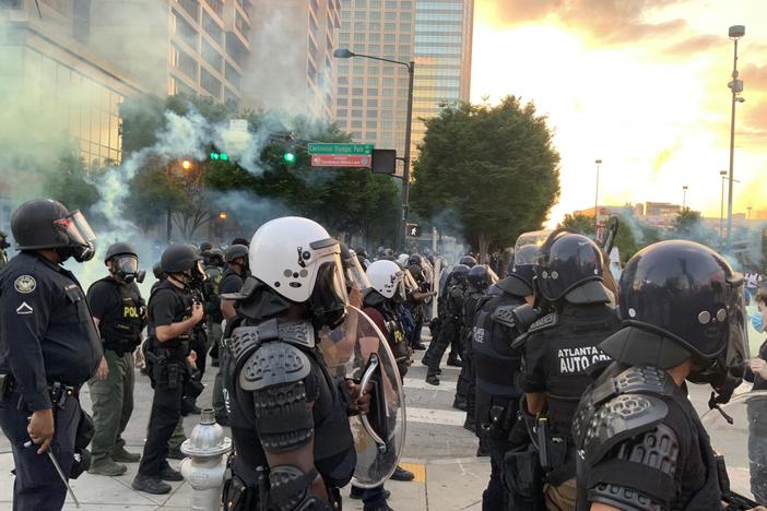 Police watch protesters in downtown Atlanta, Saturday, May 30, 2020, in Atlanta. The protesters were demonstrating against the the killing of George Floyd by police in Minnesota which has sparked worldwide protests and rioting nationwide. 