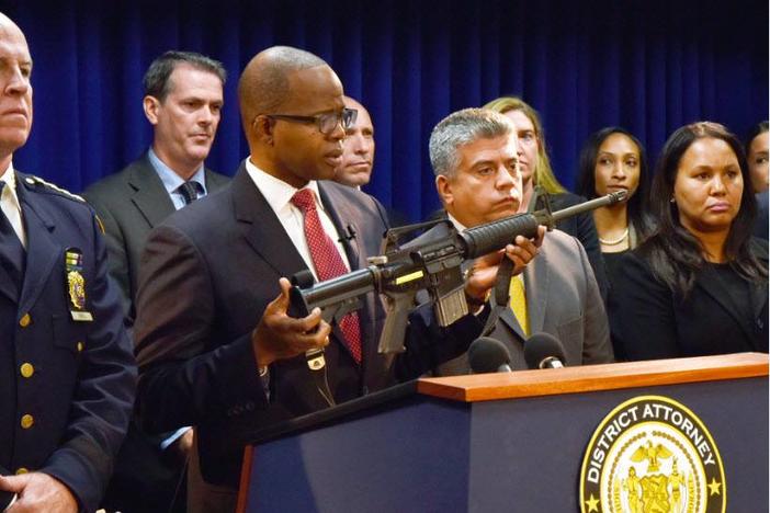 Brooklyn District Attorney Ken Thompson holds up one of the weapons seized from a gun trafficking operation that originated in Atlanta, Georgia, and Pittsburgh, Pennsylvania, and ended on the streets of Brooklyn.