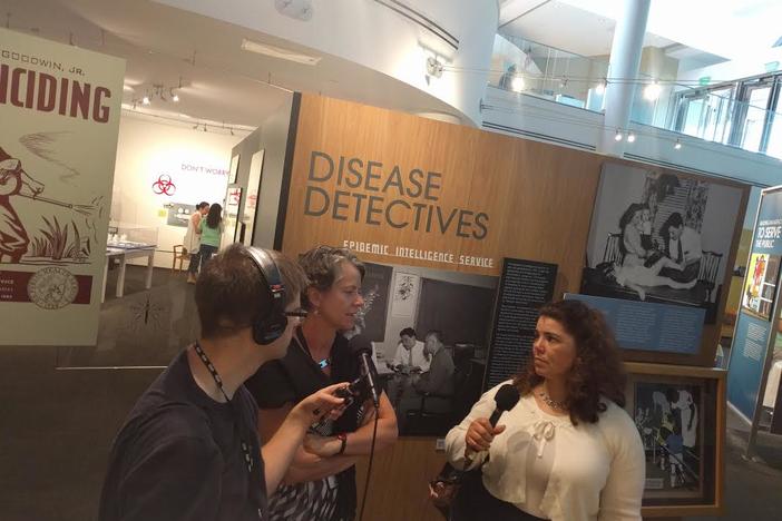 On Second Thought producer Sean Powers and host Celeste Headlee meet with Mary Hilpertshauser, the historic collections manager at the CDC's museum.
