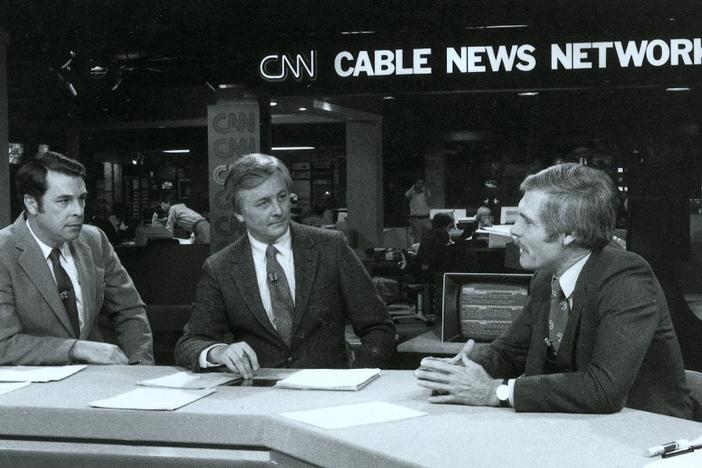 Ted Turner speaks with anchors before a CNN newscast.