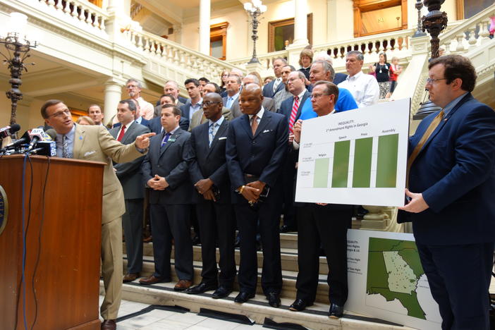 Conservative lobbyist Mike Griffin speaks at the State Capitol in front of a group of religious leaders.