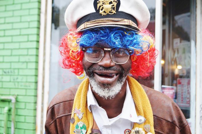 A man in a costume poses for a picture.