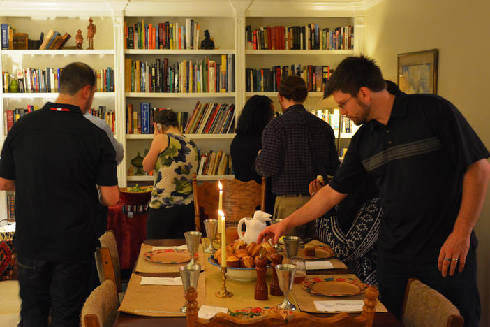 Guests gathering around the Friendsgiving buffet at the Bradfords' home in Roswell.
