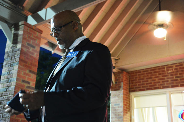 Democrat Jim Shealey pauses while addressing voters at a fundraiser in Norcross on a muggy late-summer evening.