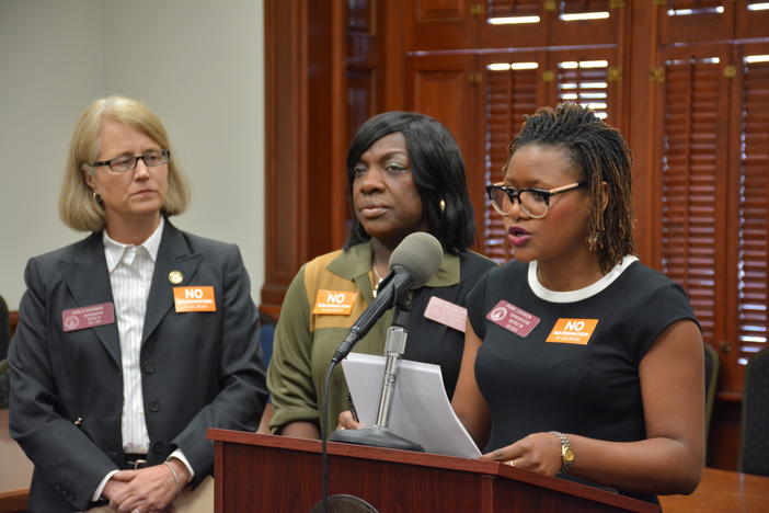Rep. Karla Drenner (D - Avondale Estates) and Rep.  Dee Dawkins-Haigler (D - Lithonia) look on as Rep. Park Cannon (D - Atlanta) speaks against HB 757.