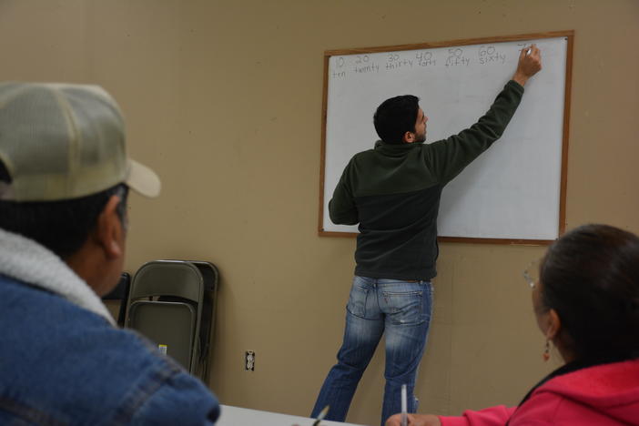 Ramon PeÃ±a teaching members of Dalton's Hispanic community how to count in English. He said Whitfield County's participation in Immigrations and Customs Enforcement's 287(g) has led to confusion and fear.