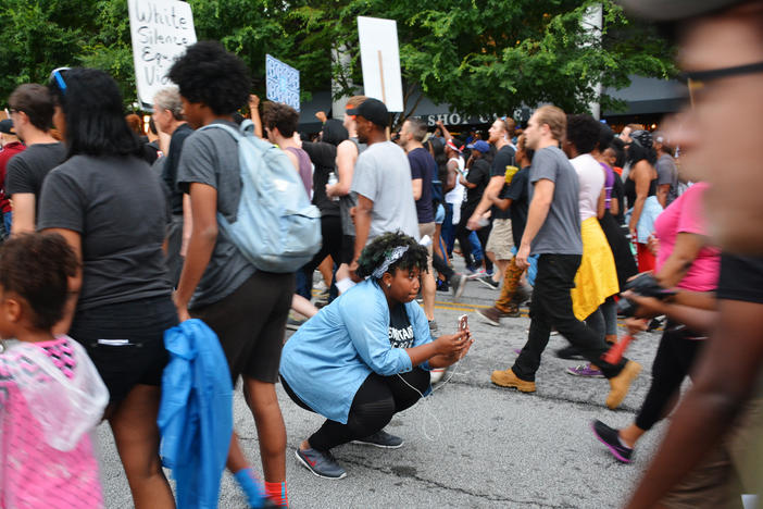 Activist Aurielle Lucier using her smartphone to stream Monday's protest in Atlanta.