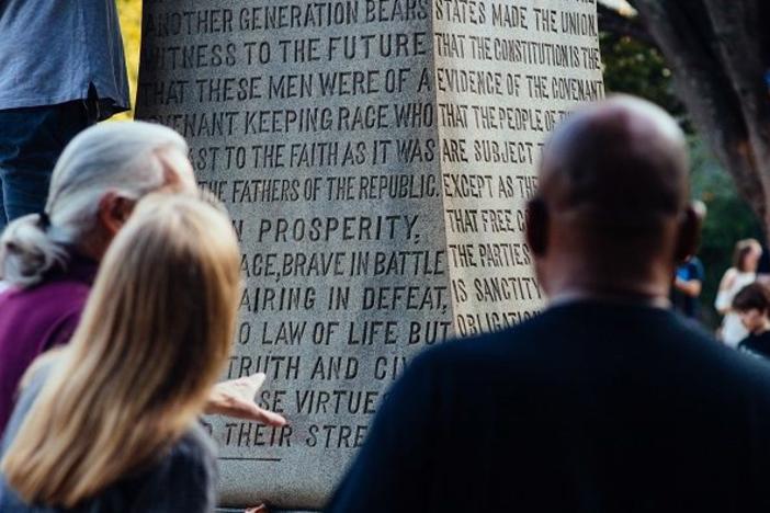 After the Stand With Charlottesville candlelight vigil on Aug. 13, 2017, in Decatur, Ga., attendees gather to discuss the controversial "Lost Cause" monument in Decatur Square.