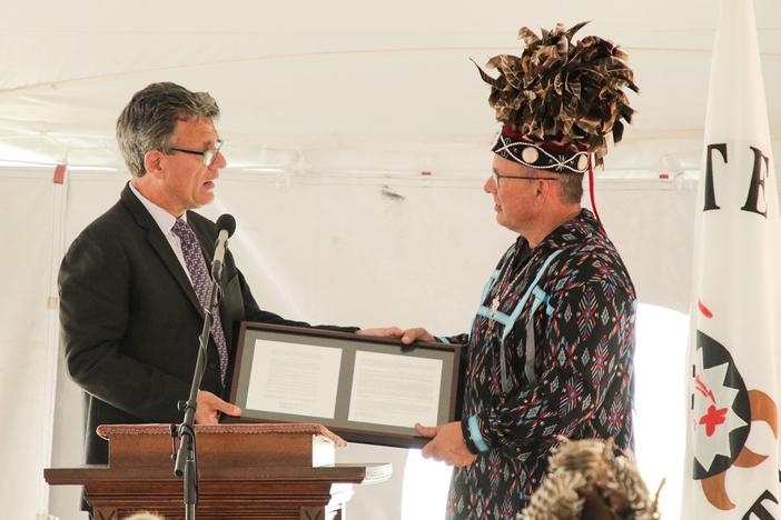 General Secretary of the United Methodist Church Global Ministries Thomas Kemper hands Wyandotte Nation Chief Billy Friend the deed to 3 acres of land in Upper Sandusky, Ohio.
