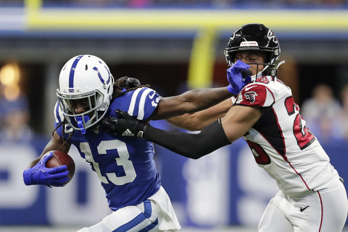 Indianapolis Colts wide receiver T.Y. Hilton (13) is tackled by Atlanta Falcons cornerback Isaiah Oliver (26) during the first half of an NFL football game, Sunday, Sept. 22, 2019, in Indianapolis. 