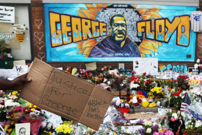 People gather at the site where George Floyd was killed while in the custody of the Minneapolis Police Department.