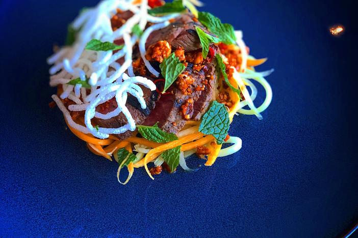 Chef Nolan Wynn's savory peanut brittle gives a sweet, salty and spicy topping to a papaya salad now available on Banshee's menu.