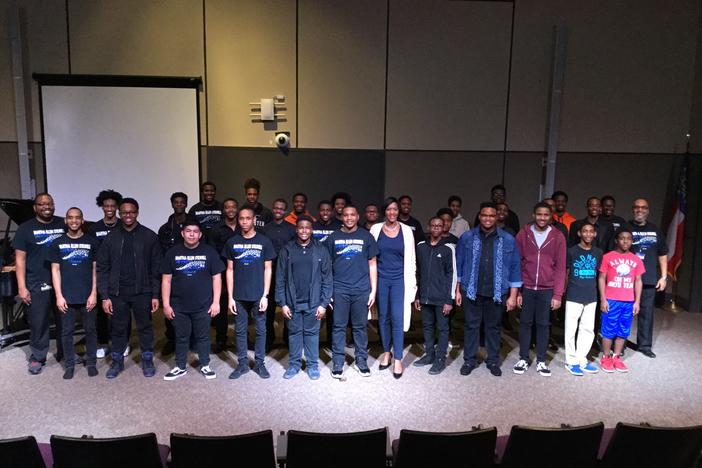 Leah Fleming poses with the Singing Brothers of Stilwell during a recent rehearsal