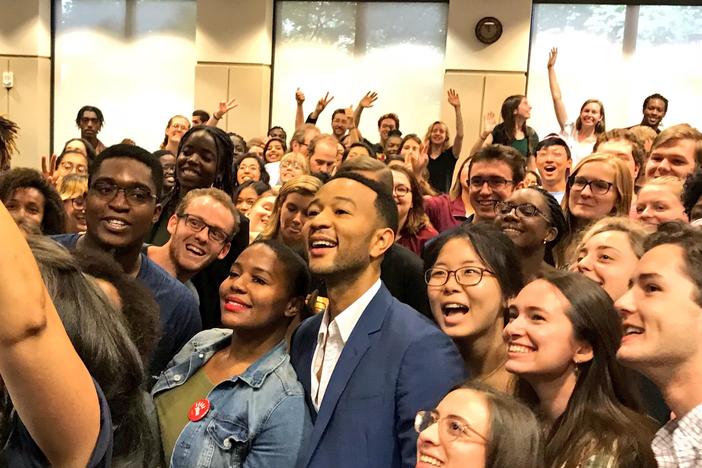 Singer-songwriter John Legend poses for a group photo with students at a Stacey Abrams campaign event.