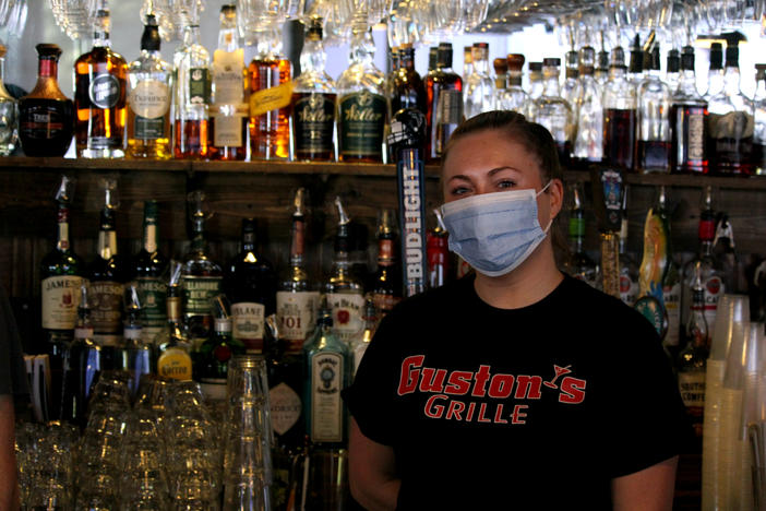 Ashley Mackay bartends at Guston's Bar and Grille in Woodstock. She's relieved the place is open for indoor dining again.