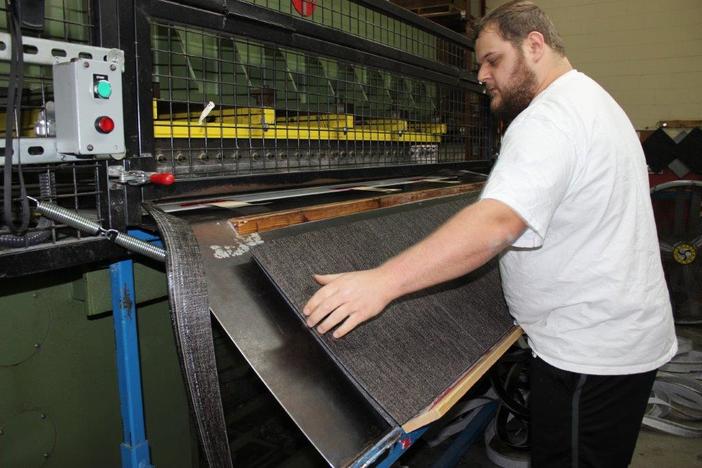 A worker guides the creation of high-end vinyl placemats, table, floor and wall coverings at the Chilewich textile factory in Murray County, Georgia. 