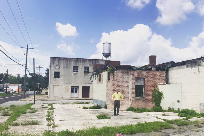 GPB's Don Smith walks around in front of the former Star Theatre on Quitman's South side. 