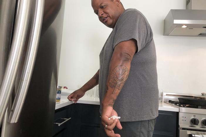 Todd Richards shows off his collard green tattoo.
