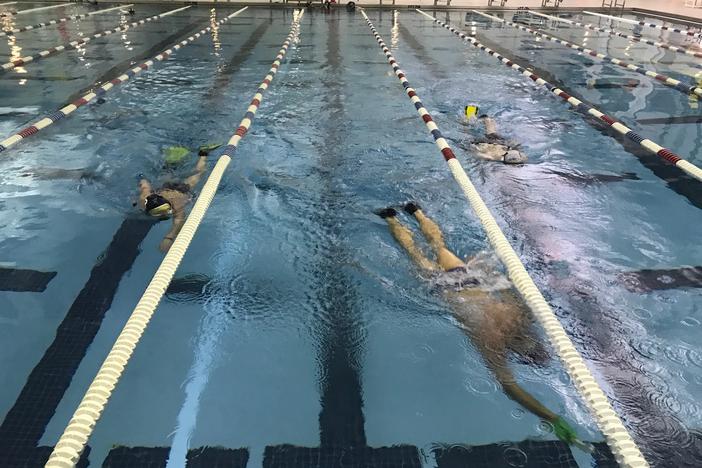 Players return from the bottom after a point is scored underwater. 