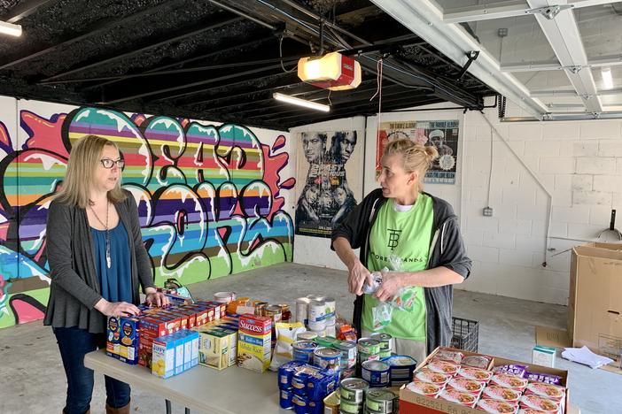 Volunteers with Neighbor In Need East Lake collect food to distribute to senior citizens who are urged to stay in their home to avoid contracting the coronavirus.