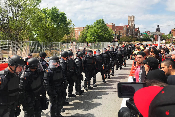 Georgia State Patrol in riot gear kept protestors 75 yards away from a National Socialist Movement rally in Newnan's Greenville Park on April 21, 2018. 