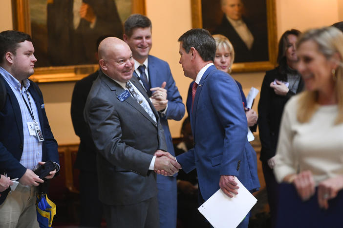 State Sen. Mike Dugan, R-Carrollton, second from left, shakes hands with Gov. Brian Kemp on the rotunda during the opening day of the year for the general session of the state legislature, Monday, Jan 13, 2020 in Atlanta. 