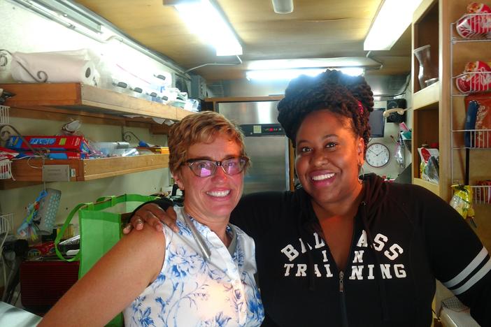 Stephanie Morales and Kalena Boller on Stephanie's food truck during a TV production in Stone Mounrtain.