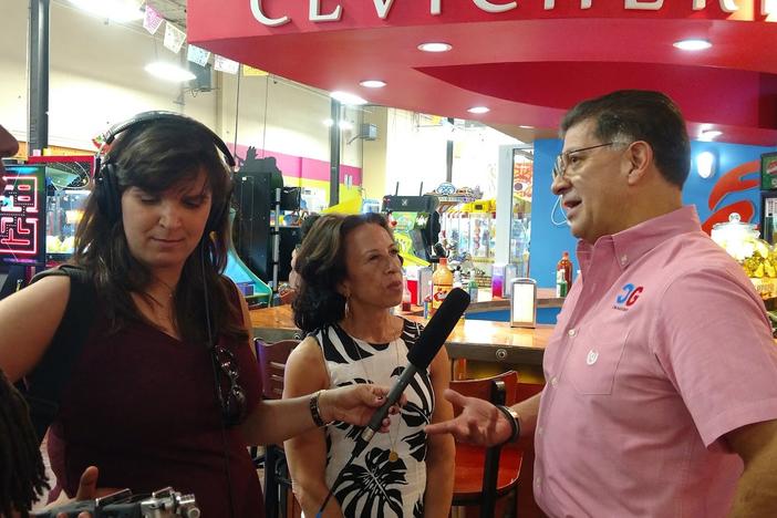 (l to r): Latino USA producers Zakiya Gibbons and Jeanne Montalvo Lucar listen as host  Maria Hinojosa interviews Carlos Chavez, a restaurant owner at Plaza Fiesta in Chamblee, Georgia.